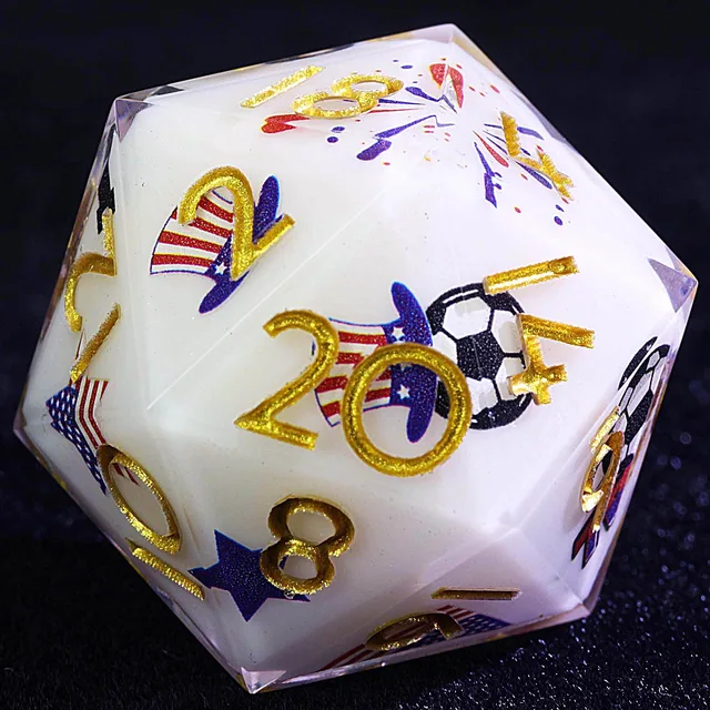 Close-up of a white D20 with a gold 20, red-and-blue star-and-stripe patterns, and a soccer-ball graphic.