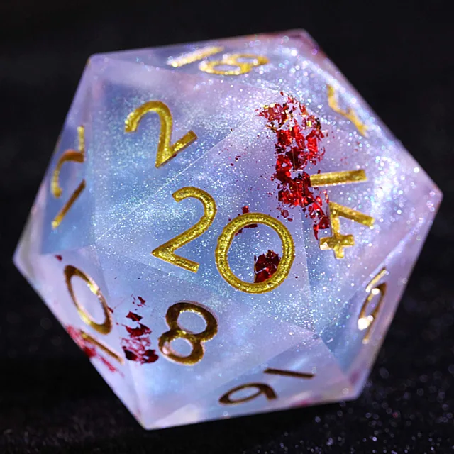 Close-up of a blue and pink glittering D20 with red foil flecks and gold numerals.