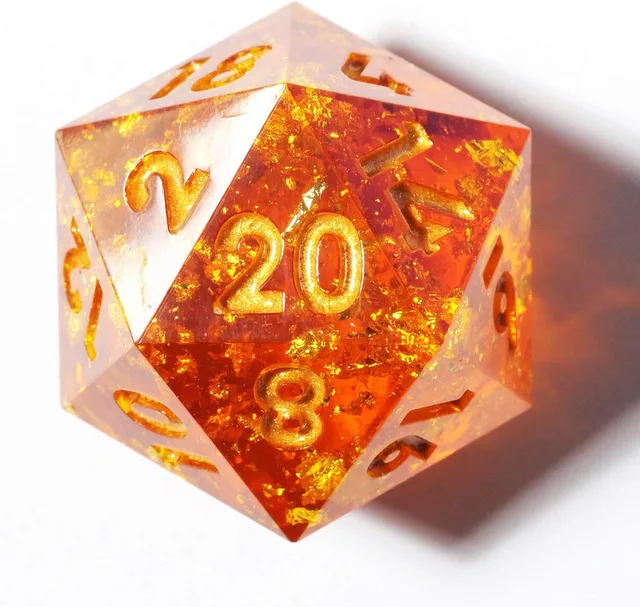 Close-up of a transparent orange D20 with gold-coloured flecks and numbers.