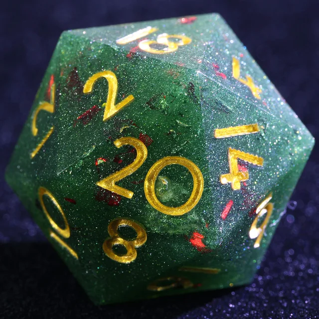 Close-up of a green glittered D20 with red flecks and gold-colored numbers.