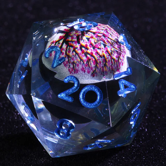 Close-up of a clear D20 with blue numbers and a pink-blossom tree core.