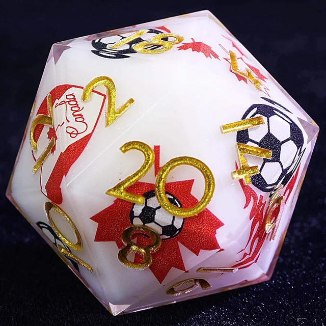 Close-up of a white D20 with a red maple leaf, soccer-ball graphics, and gold-coloured numbers.
