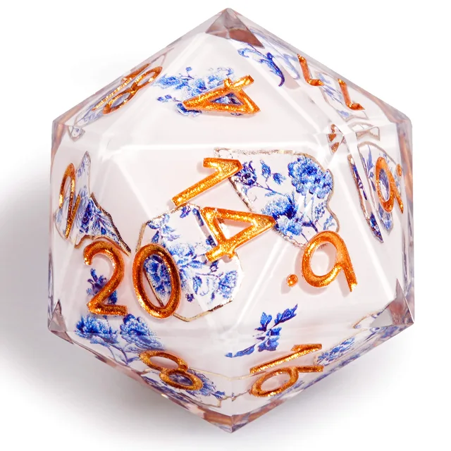 Close-up of a white D20 with blue flowers and orange-gold numbers.