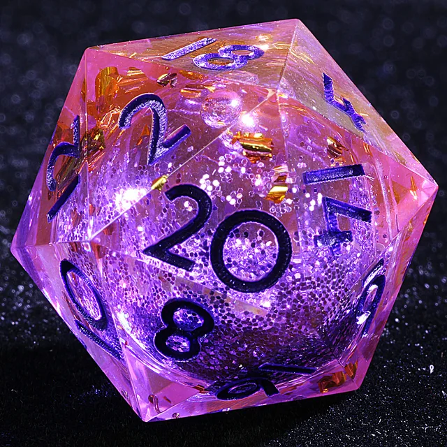 Close-up of a pink-purple liquid-core D20 with purple sparkle, gold-coloured flakes and dark numerals.