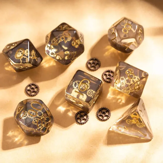 Translucent smoky grey and brown polyhedral dice with gold numbers and gear patterns, including a triangular d4 and cube-shaped d6.